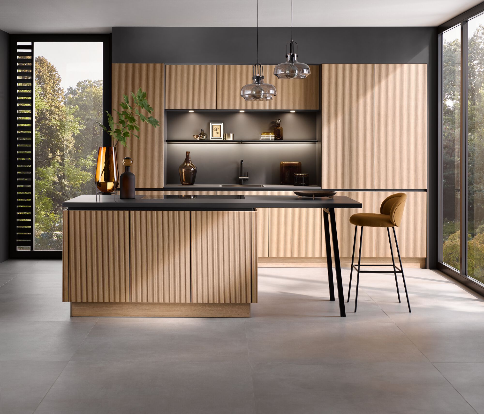 Contemporary oak kitchen with fluted cabinetry, black worktops and pendant lighting